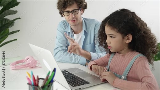 Caucasian father help student doing homework about engineering code while happy school girl. Dad take care cute child while teaching about generative ai at table with laptop and headphone. Pedagogy.