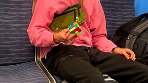 Pro Rubik's cube solver stuns train passengers with epic one-handed skills