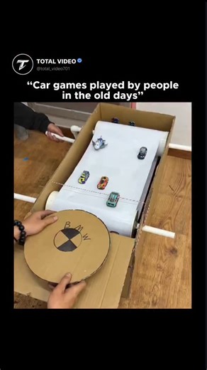 TOTAL VIDEO on Instagram: "The video features a clever DIY racing simulator crafted from cardboard, PVC pipes, and toy cars, utilizing a manual conveyor belt to mimic a moving highway. One person operates a hand-crank to rotate the paper "road" while the player navigates a cardboard steering wheel to dodge obstacles, showcasing an ingenious mechanical design that functions entirely without electricity. Posted by @ sciencegirl on January 28, 2026, this repost of a ViralRush clip has already amass