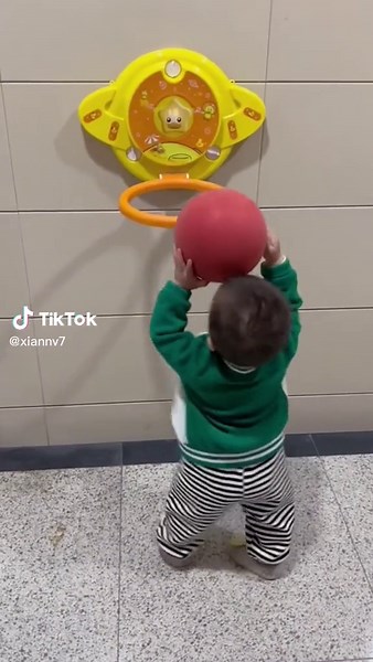 Toddler Playing with Colorful Toy Basketball Hoop