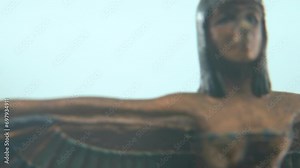 Dreamy macro shot of a Cleopatra statue with wide open wings, hazy depth of field, ancient Egypt Queen of Kings, Egyptian historical ruler, antique artwork of a goddess, rotating cinematic 4K video