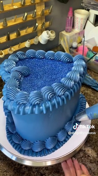 Navy blue glitter heart cake. #Cake #Cakes #ButterCream #ButterCreamCake #ButtercreamPiping #CakeTutorial #CakeDecorating #CakeDecoratingTutorial #HeartCake #VintageCake #VintageHeartCake #Wilton #WiltonPipingTips @Wilton Cakes