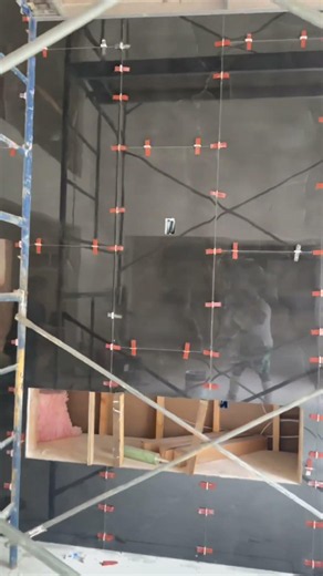 Fireplace wall Tile installation in progress #tile #fireplace #construction