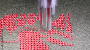 needle of the sewing machine during the automatic processing of embroidery on canvas