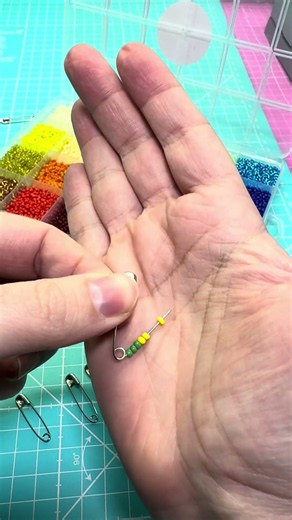 Step-by-step instructions for making a beaded brooch with safety pins to cheer on your national t...