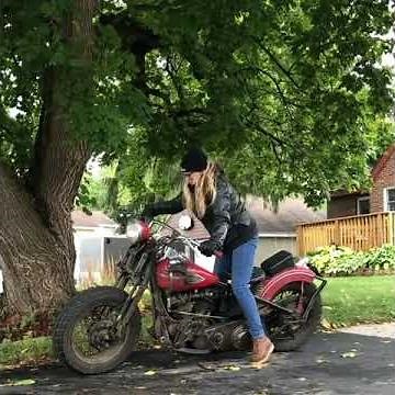Biker girl kick start vintage Harley-Davidson motorcycle