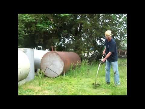 Trimming tall grass with old weed eater