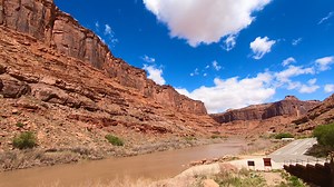 Utah State Route 128. Utah State Route 128, also known as the Upper Colorado River Scenic Byway or River Road, is a scenic 44.6-mile highway near Moab that follows the Colorado River through a canyon. It's known for its dramatic red rock cliffs, winding drive, and numerous pull-offs, and offers access to recreational areas like the Fisher Towers and Grandstaff Canyon. It is a popular but remote drive with few services. Please note all videos on this page were taken by us on our road trips in the