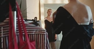 Extravagant crossdresser adjusting dress in dressing room Stock Video