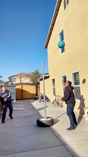Father-Son Tetherball Game: A Fun Family Competition