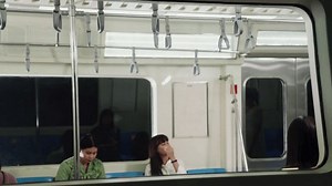 Crowd of people on a busy crowded public subway train travel . Commuting and urban lifestyle concept .