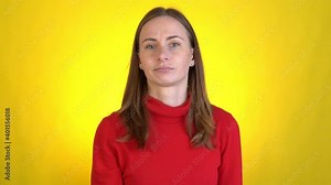 Woman switches channels with remote control watches TV on a yellow background. Man views his favorite program