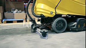 Industrial floor cleaning machine in warehouse, A detailed shot of an industrial floor cleaning machine operating in a warehouse environment Stock Video
