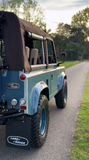 1997 Land Rover Defender 90 300TDI Soft Top finished in Heritage Blue. A frame up restoration, stripped to a bare chassis and refinished with three layers of HD coating, ✨ Highlights: 🟤 Chocolate brown mohair soft top 🛡️ Galvanised cappings HD internal cage 🪑 Full chocolate leather with Alcantara (dash, doors, cubby, 4 tip-up seats) ❄️ Air conditioning 📱 10.1” touchscreen with Apple CarPlay Bluetooth 5.0 🌳 Custom teakwood floors front and rear 🛞 Heritage Blue Wolf rims with 255/85 R16 tire