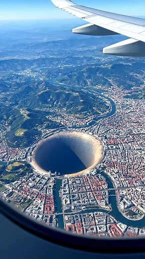210K views · 282 reactions | High above Bilbao, Spain, a massive, perfectly circular hole stretches into the ground near the edge of the city. The Basque hills and winding river surround it, the scene still, silent, and impossibly deep. #spain #fblifestyle #coldfront #winterweather #earthimpacts This content isn’t real — it’s a simulated ‘what if’ scenario created by AI for visual exploration. | Earth Impacts | Facebook