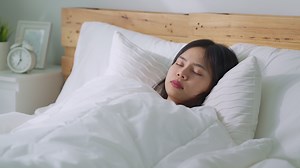 Download Woman waking up in bed for free