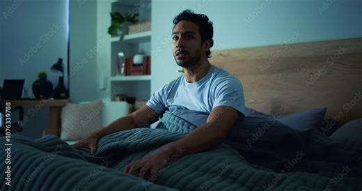 Scared, man and nightmare in bedroom at night from psychosis, ptsd flashback and panic attack. Shocked, male person or fear reaction of bad dream, emotional trauma and terror of hallucination in home