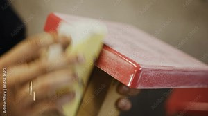 A man licks with sandpaper the surface of a metal bag with the inscription - This is my game. Close-up. Stock Video