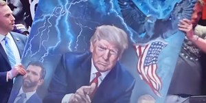 Eric Trump accepts ‘Q’ painting of his father at controversial conference