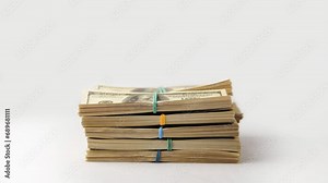 Dollars money stack, cash income, cash profit concept. Stacks of dollar money appear and fold into large stack on white background. Close-up