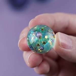 Galaxy sphere necklace. Use 'ballmold20' to get 20% off. https://www.amazon.com/dp/B09PQN4SDB?maas=maas_adg_E68AD1A09277A0E3248FE9949699E1B5_afap_abs&ref_=aa_maas&tag=maas #resin #Jewelry #resinjewellery #planet #sphere #necklace | Let's Resin