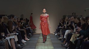 A lust red corset dress with sweetheart neckline and a twisted rose draped on the front. From the Autumn/Winter 2019 collection: on.AlexanderMcqueen.com/AW19Womens | Alexander McQueen