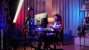 Asian Boy Streamer Having A Backache While Playing Game On Computer. Live Stream