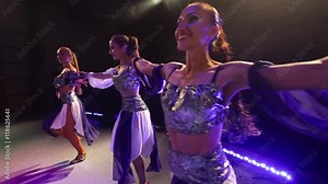 young women in traditional Jewish dress dancing on stage