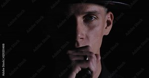 Vape man. a handsome young white guy in a modern black cap vaping and letting off puffs of steam from an electronic cigarette