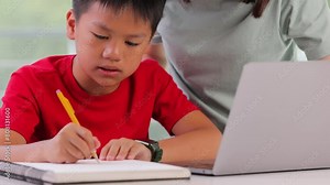 Mother helping her 10 year old son with his homework.