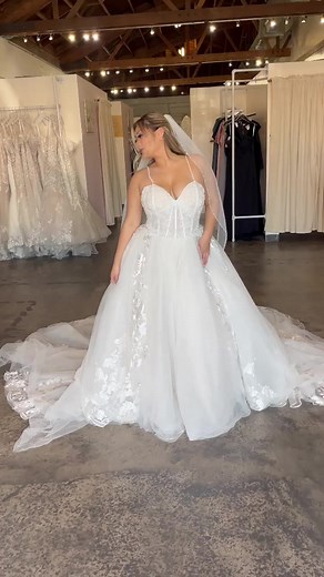 We just pulled your dream dress! 🚨😍🥂 One of the dreamiest ballgowns ever! Princess corset top with an extravagant tulle ballgown with waterfall details throughout. She's a dress come true! Follow us for more extravagant wedding gowns! 💃🏽 #ballgown #weddinggown #ballgowns #weddingdress #tulleweddingdress #princessweddingdress | Strut Bridal Salon