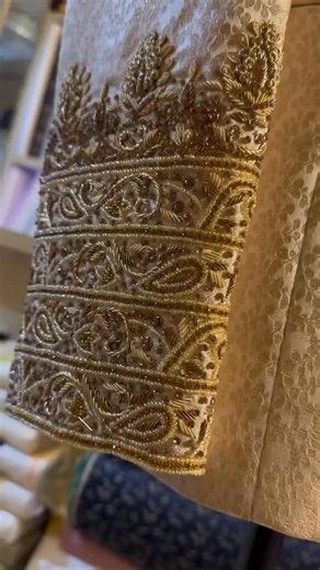 A classic ivory sherwani from Enigma by Wasay Ansari, crafted for the modern groom who values tradition with sophistication. The subtle jacquard fabric adds a rich texture, while the intricate hand-embroidered collar and cuffs elevate its regal charm. Paired with a gold pocket square and layered pearl mala, this ensemble perfectly captures the grandeur of Indian weddings — elegant, powerful, and graceful. Ideal for reception, wedding day, or royal-themed events. #EnigmaByWasayAnsari #WasayAnsari