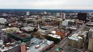 A drone shot of Downtown Columbia, SC. With a church and the state capital visible.