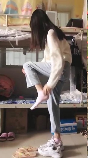 taking off her shoes and socks quickly