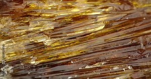 yellow calcite crystal rotating in 4k. macro detail texture background. close-up raw rough unpolished semi-precious gemstone