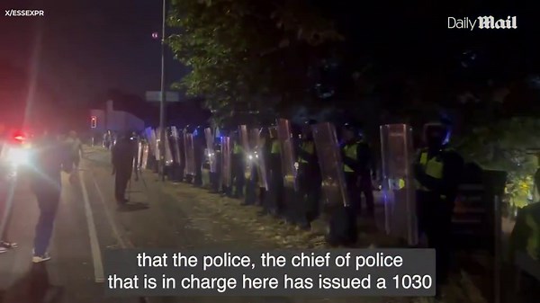 Line of riot police stands firm in front of Epping Bell Hotel