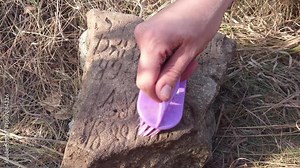 Cleaning an ancient monument, cleaning a stone monument with a counting rod