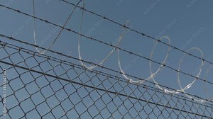 Barb wire on the top of a fence