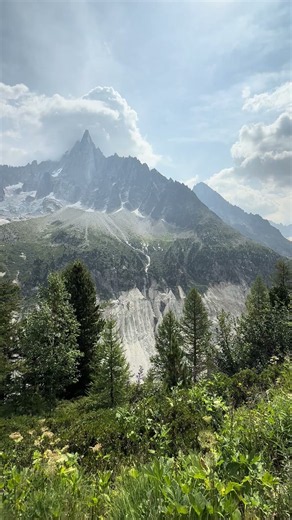 Lush Green Valley in the Alps with a Close Up of a Waterfall from Glacier Runoff in Chamonix, France