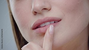 Model young woman mouth smiling happy beautiful soft lips showing healthy teeth dental lead by hand on the face attractive female happy health cosmetics young slow motion