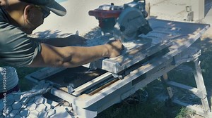 Tiler cutting the tile with a circular saw. The perfect tile-cutting blade for a circular saw when cutting porcelain tile is the diamond blade.