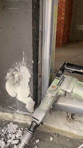 Jackhammer in Action: Demolishing a Concrete Wall