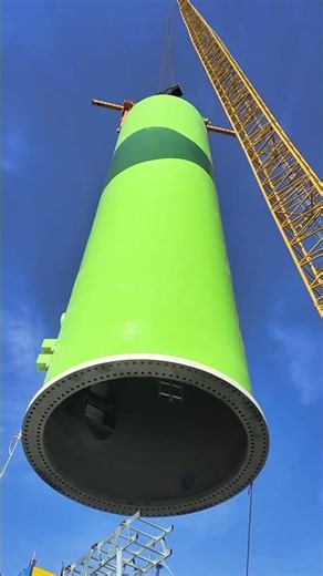 Installing a giant industrial fan at a height of 100 meters.