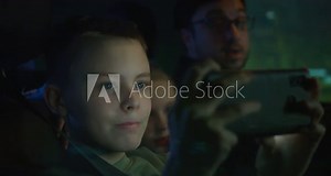 Man driving and son using phone camera