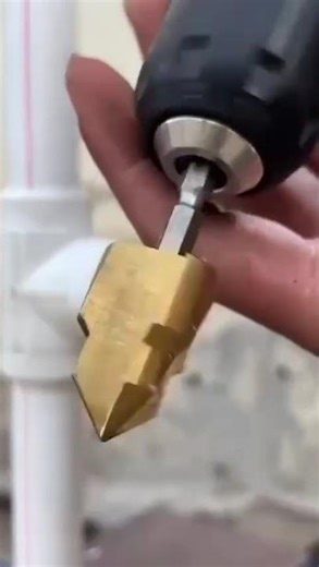 the process of drilling a hole in a PVC pipe using a drill in preparation for opening a pipe