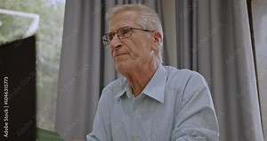 Older male professor or teacher giving a lecture to students at a university