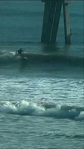 Surfers catch some nice waves near the Jacksonville Beach pier