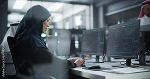 Arab Female Artificial Intelligence Engineer Working on Desktop Computer in a Startup Office. Young Middle Eastern Specialist Writing Software Code for an Innovative Big Data Blockchain Project