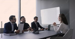 Young female applicant pass job interview in company office with three male HR managers ask questions listen answers of confident woman position candidate. Formal meeting in boardroom, human resources