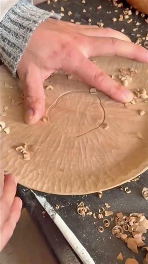 Skilled Artisan Carving Intricate Patterns On Round Wooden Plate